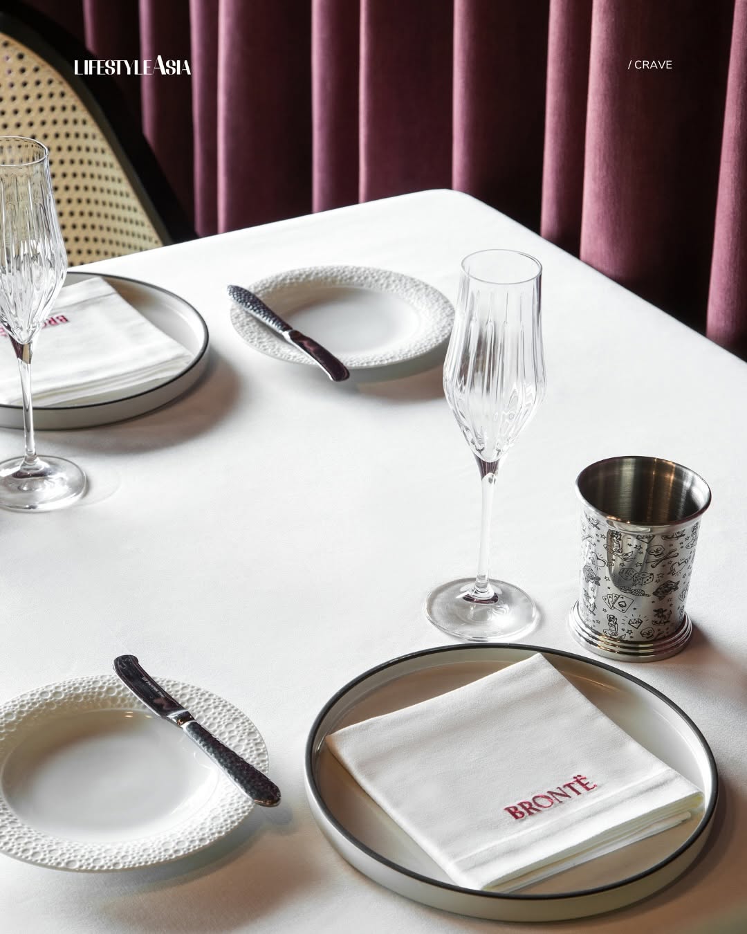 Brontë place setting — crystal glassware, linen napkin and signature Brontë silverware